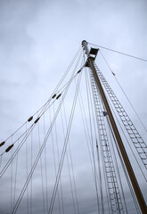 looking up at ship sails at dusk on cloudy night (sailor sailing boat sailboat) mast down sail platform top view night nightfall rope ladder clipper sooner maritime marine travel navy clouds