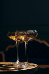 Two glasses of champagne illuminated by the sun's rays