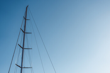 A captivating and striking silhouette of a tall communication tower lasting against a clear blue sky above © Flash Vector