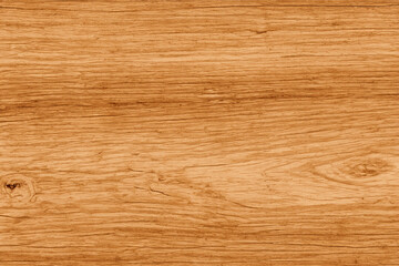 Closeup of light brown wood grain with a knot.