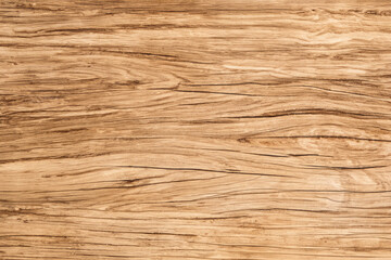 Closeup of a light brown wood surface with a grainy texture.