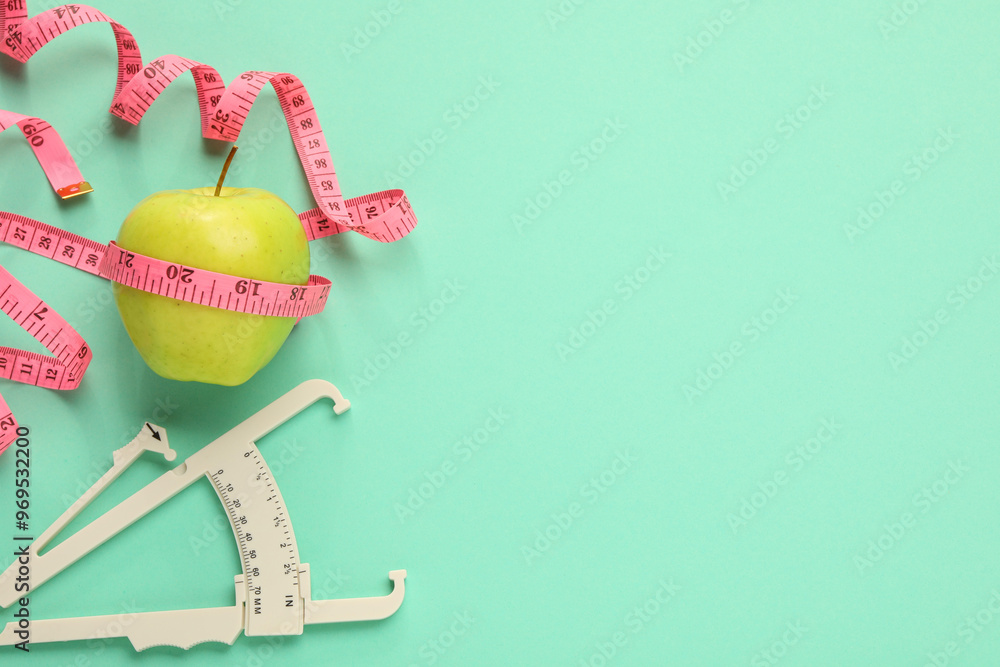 Poster Body fat caliper, measuring tape and apple on turquoise background, flat lay. Space for text