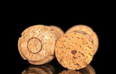 Two wine corks, macro, isolated on black background.