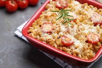 Delicious al forno pasta in baking dish on grey table, closeup