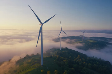 Three wind turbines on a misty hillside during sunrise, highlighting renewable energy in a serene landscape