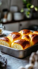 Freshly baked golden brioche rolls in a kitchen setting