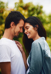 Fototapeta premium Love, smile and couple in park, care and bonding together with happiness, trust and relationship. Outdoor, man and woman in backyard, marriage and romance with fun activity, commitment and dating
