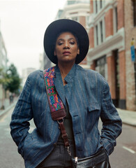 Analog portrait of proud mature woman standing in a London street.