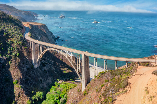 Beautiful scenery of Pacific Ocean coast along Highway 1 and Big Sur, wonderful aerial view of Bixby Bridge, sunset, sunrise, fog. Concept, travel, vacation, weekend