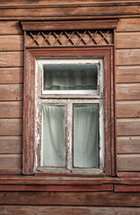Old wooden window on the ancient abandoned house