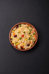 Boiled wheat bulgur porridge with vegetables peppers, peas, corn