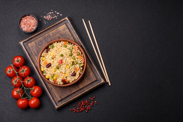 Boiled wheat bulgur porridge with vegetables peppers, peas, corn