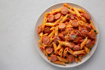 Homemade One-Pot Hot Dog Pasta on a Plate, top view. Flat lay, from above. Copy space.
