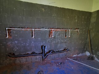 renovation of a public toilet. Install of new drainage and water pipes on urinals in public toilet