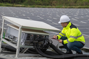 Engineer working at floating solar farm,checking and maintenance with solar batteries near solar panels,supervisor Check the system at the solar power station