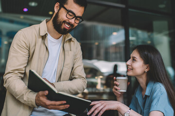 Ethnic man sharing data with female colleague