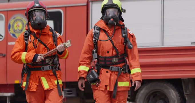 A group of prepared firefighters stands ready for hazardous tasks involving rescuing victims and extinguishing fires, exemplifying their dedication and bravery in the face of emergencies