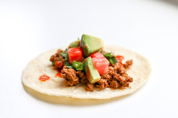 Taco with avocado and tomato