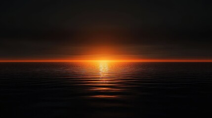 Obraz premium The horizon glows as the sun sets, casting a warm light across the water's surface, creating a serene atmosphere at dusk