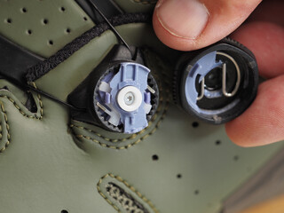 Broken mechanism lock for shoe laces boa on cycling shoes.