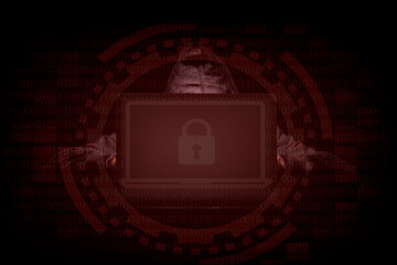 A person in a dark room using a laptop with a lock logo, internet phishing, hacking, data security threats, data breach, cyber security concept