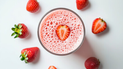 A glass of pink strawberry milkshake or cocktail, seen from above, against a white background.