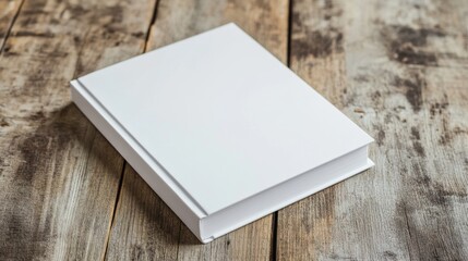 Fototapeta premium Blank white book cover mockup on a wooden table for minimalist design applications