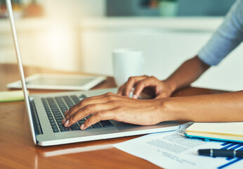 Business person, hands and typing with laptop for email, communication or research on desk at home. Closeup, freelancer or journalist with computer for remote work, online browsing or app at house