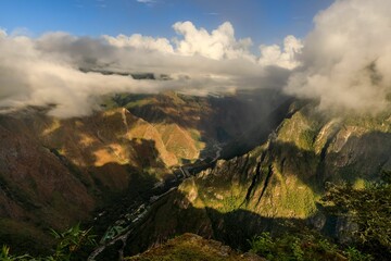 Aerial view of mountain valley with river and clouds