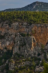 Drone scenic view of canyon covered with greenery on a sunny day in the suburbs of Marmaris, Turkey