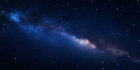 Fototapeta premium A view of the Milky Way galaxy stretching across the dark night sky, filled with stars and cosmic clouds, showcasing the vastness of space, selective focus