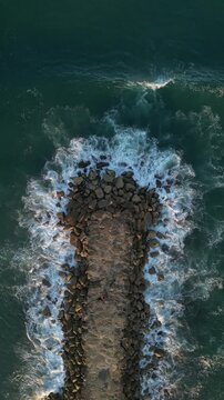 Aerial view over a rocky shore in Atlantic Ocean at the daytime in Lisbon, Portugal