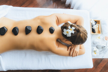 Panorama top view hot stone massage at spa salon in luxury resort with day light serenity ambient,...