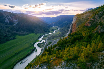 Aerial top view sunset landscape Altai mountains white rock with green forest and winding river, drone photo