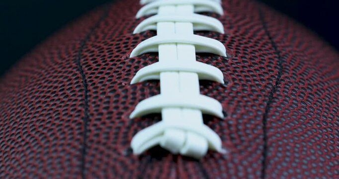 White leather laces of American Football in and out of focus