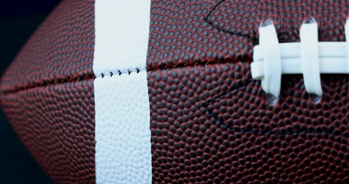 Pan left to right of American football ball laces