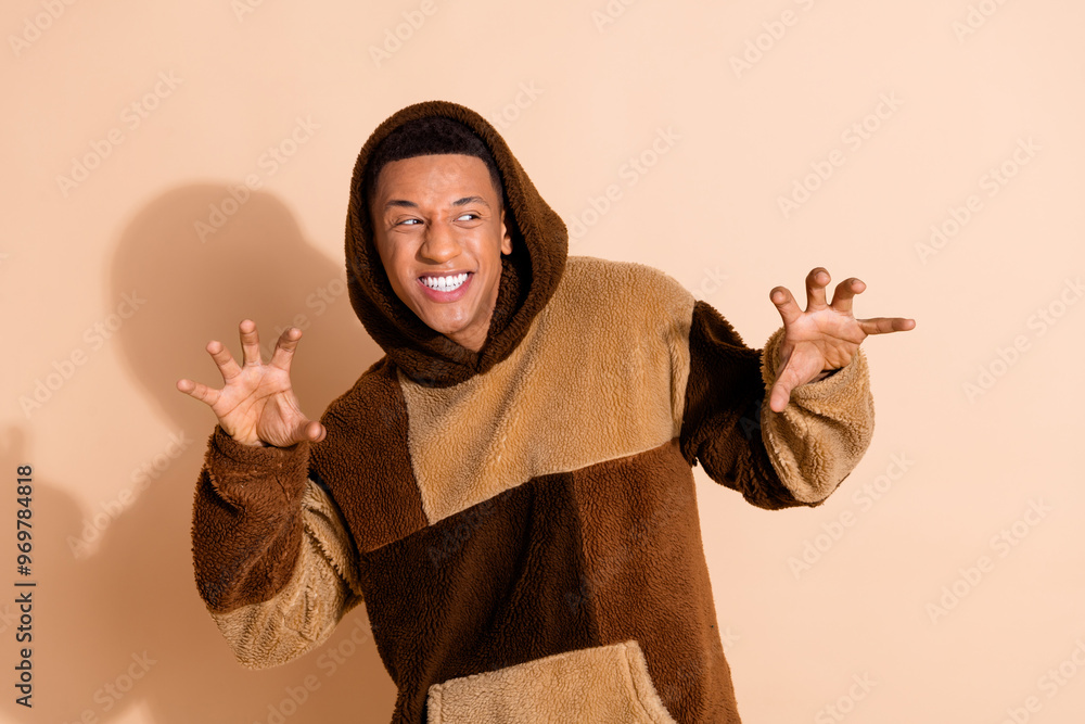 Canvas Prints Photo of good mood guy with stylish haircut dressed plush hoodie look at event promo empty space isolated on beige color background