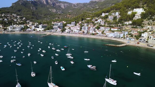 Aerial reveal of harbor with yachts in Port de Soller coastal town, Mallorca	