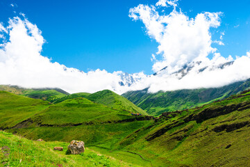 Obraz premium Beautiful view of the high green mountains among the clouds. The North Caucasus. Russia