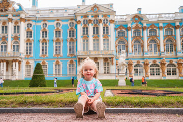 Little girl child walks to Catherine's Park with a palace, family tourism, active childhood.