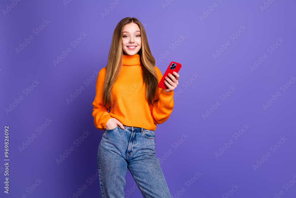 Poster Portrait photo of youth charming blonde hair cute happy smile girl in orange turtleneck using smartphone cheerful isolated on violet color background