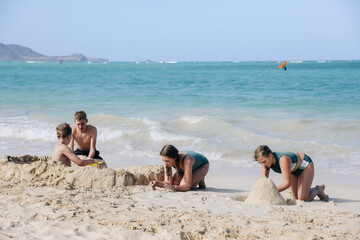 Fototapeta premium Kids playing in sand and water.