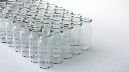 New glass vials for instrumental analysis on a white background. analytical vials prepared for chemical analysis