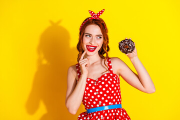 Photo of pretty cute adorable dreamy lady wear red trendy clothes hold dessert empty space isolated on yellow color background