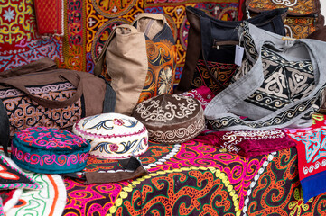 The local market presents colorful traditional embroidered bags and hats with intricate patterns of the East, the culture of central and Central Asia