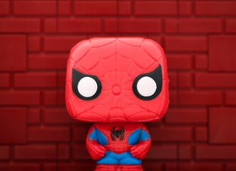 Naklejka premium Tambov, Russian Federation - August 23, 2024 Spider-Man Funko POP Mini Vinyl Figure against a red brick wall background.