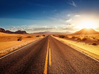 Naklejka premium empty Asphalt road through desert in warm sunset