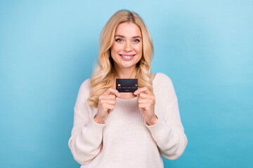 Photo of charming lovely nice woman wear stylish white clothes hold bank card isolated on blue color background