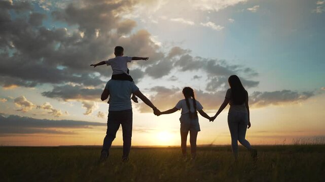 Happy family enjoying fun in nature. Parents lifting child in sunset field. Family bonding in scenic outdoor setting. Concept family nature fun together. Joyful family moments nature. nature adventure