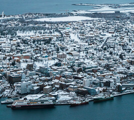 A panorama wide shot of the harbour city of Tromsø, Norway, in winter.